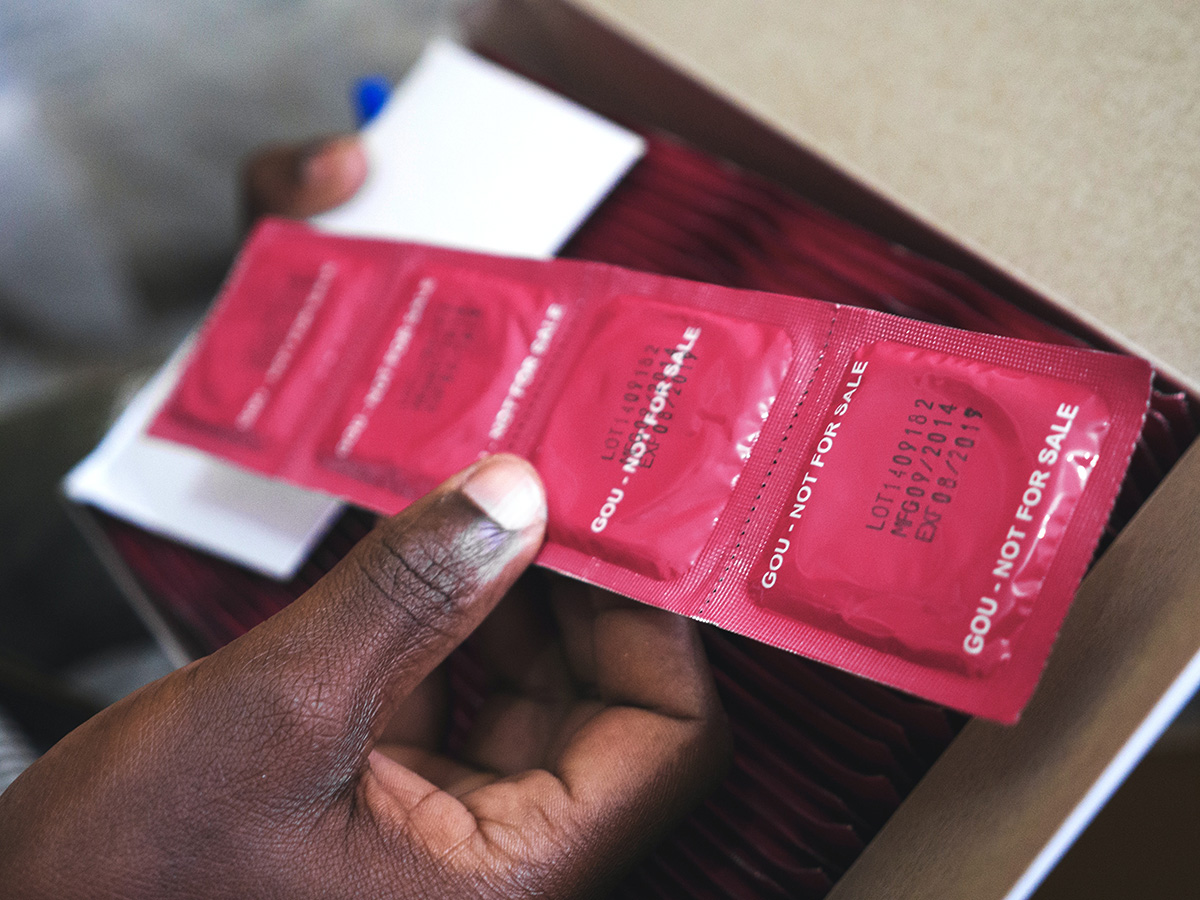 Young person holding condoms