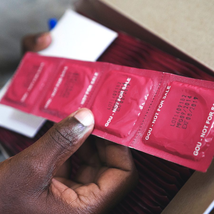Young person holding condoms